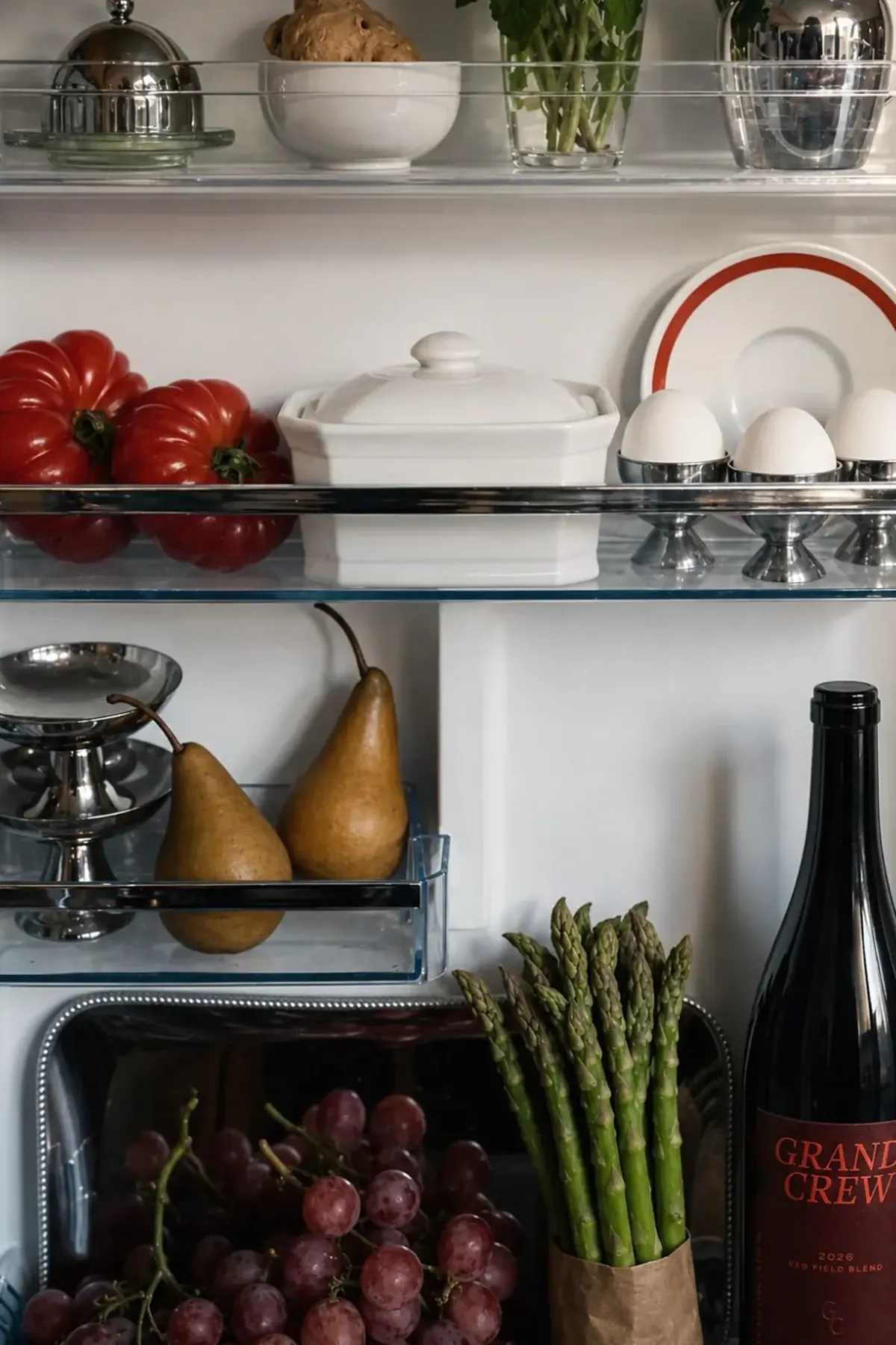 Red blend placed with food inside a styled refrigerator, concept work