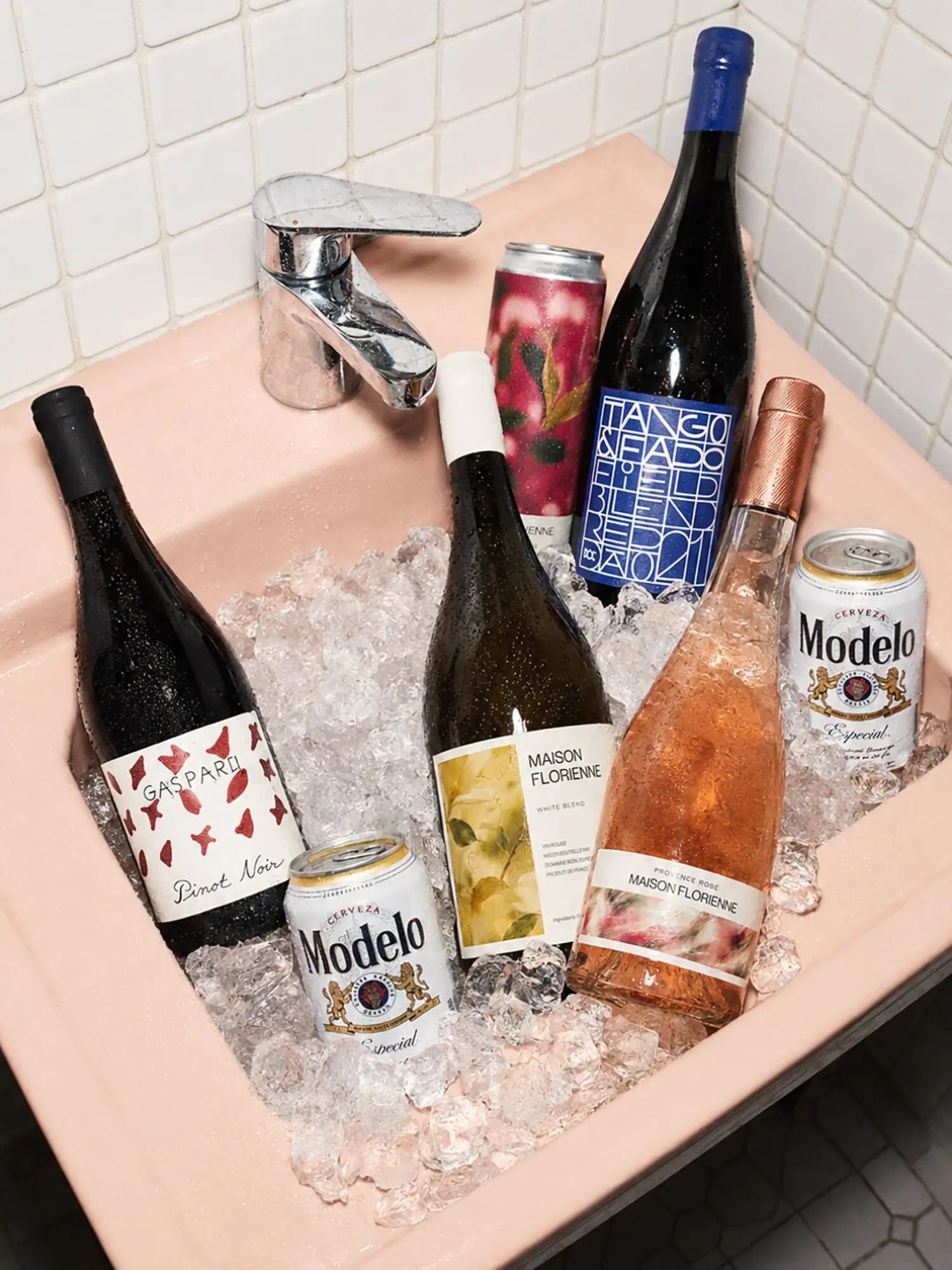 Wine bottles, canned drinks and beer chilled together in a sink
