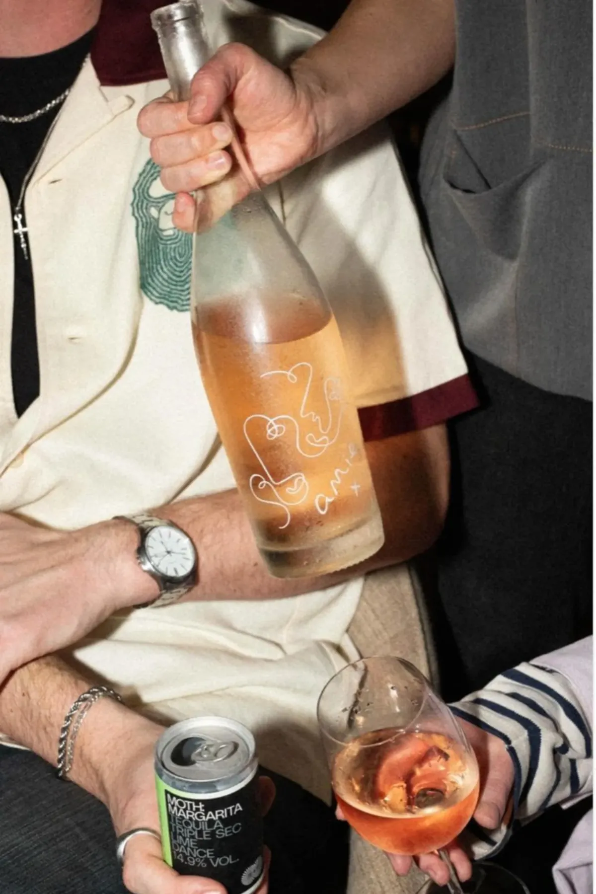Friends sharing rosé and a canned cocktail in the same social occasion