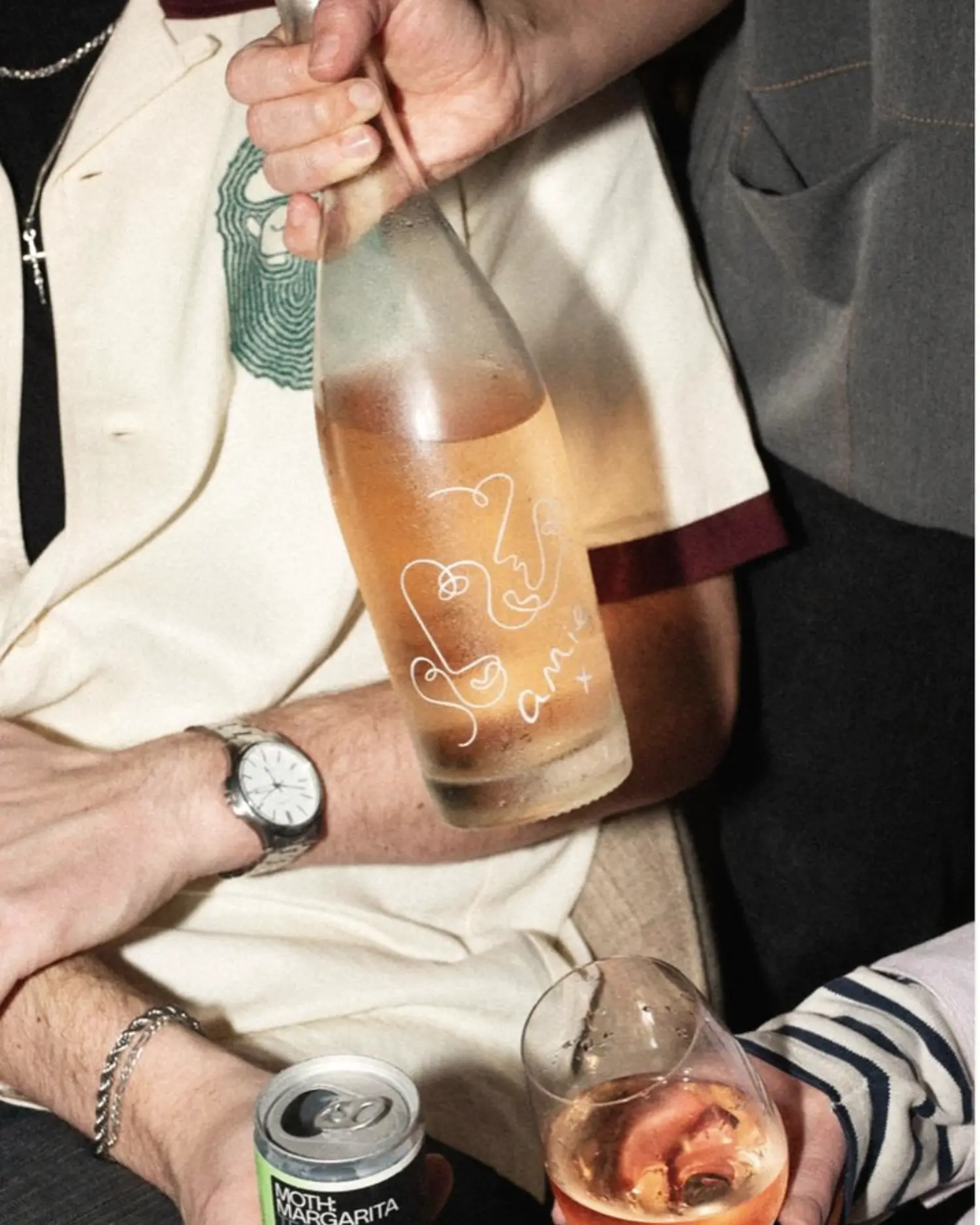 Friends sharing rosé and a canned cocktail in the same social occasion