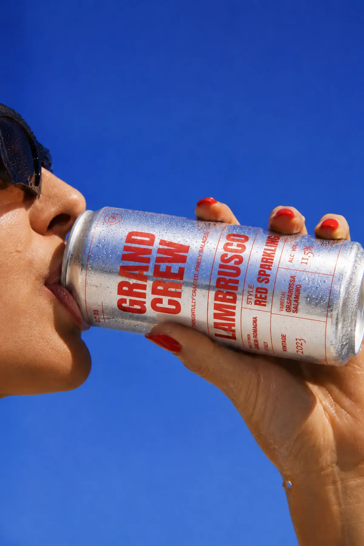 An energy drink can held in the hand it is drunk from
